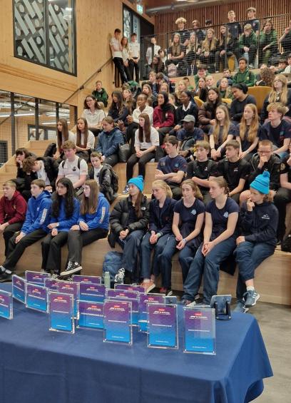 Photo of all the young people sitting as a group at the F1 in Schools event