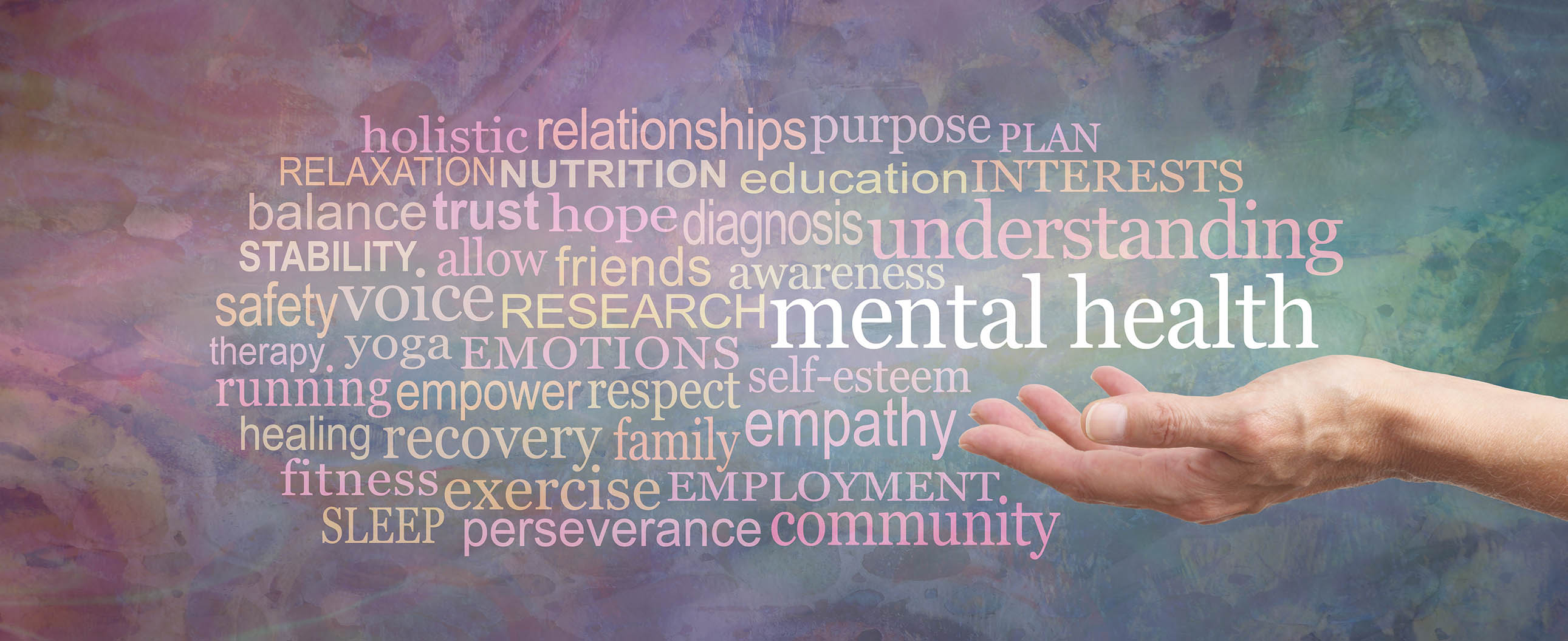 Hand reaching towards words about mental health on a colorful background